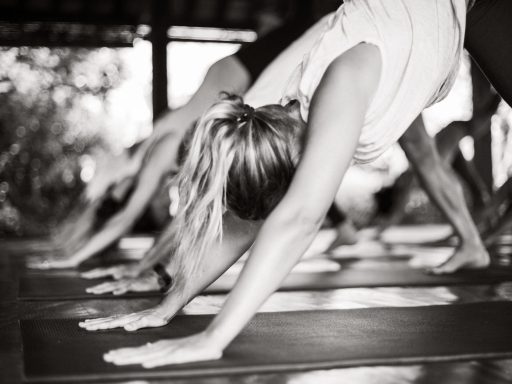 YOGA CLASS_HIGH (13 of 73) People doing yoga, specifically in a pose resembling Downward-Facing Dog.
