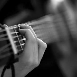 Someone's hand playing the guitar.