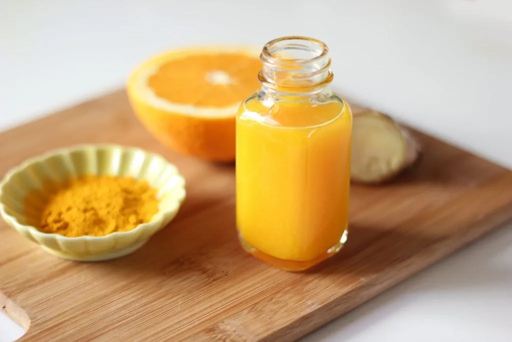 orange juice made using natural ingredients such as oranges, turmeric, and ginger