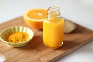 orange juice made using natural ingredients such as oranges, turmeric, and ginger