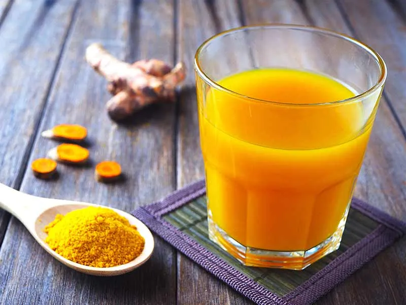 orange-colored drinks, most likely turmeric juice